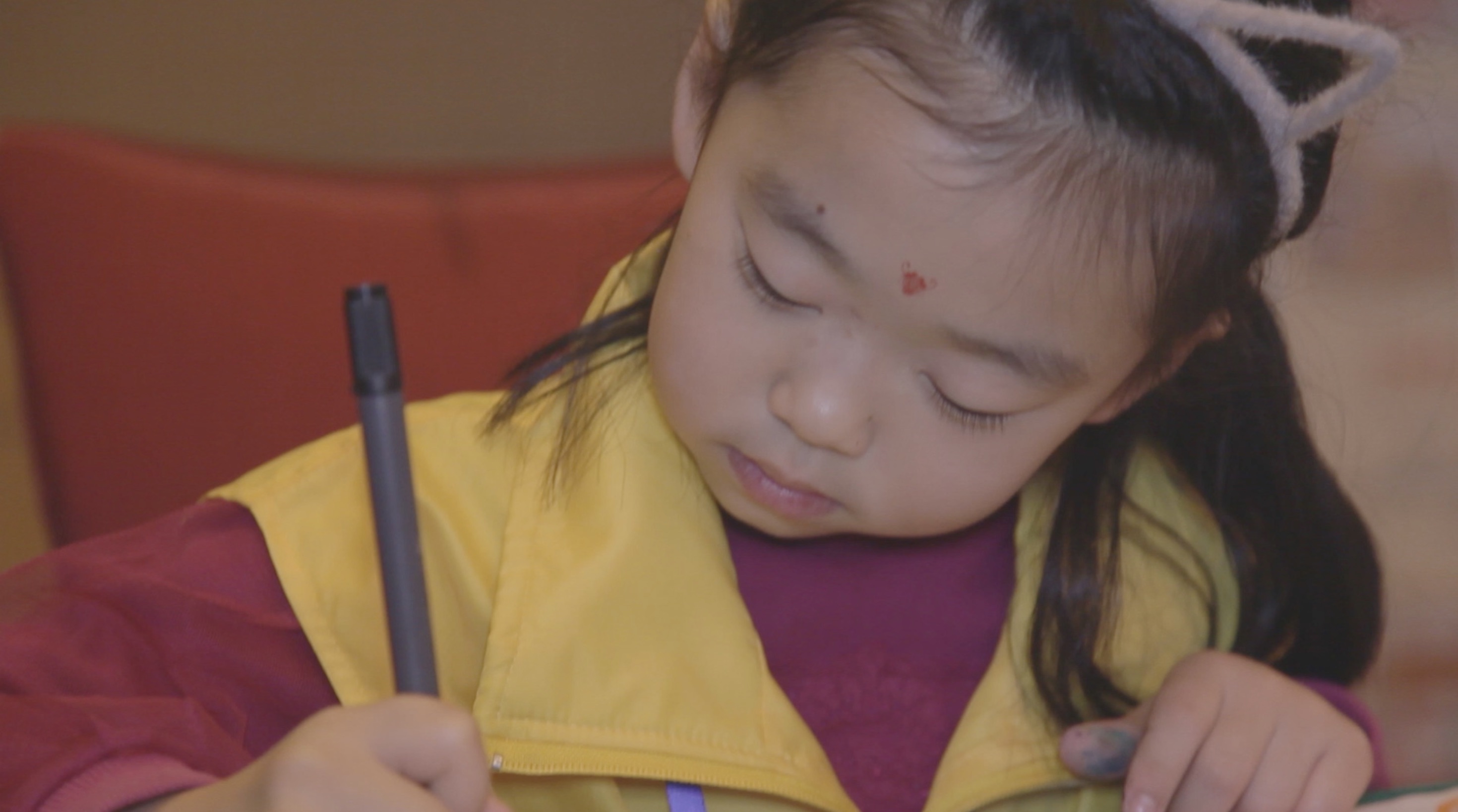 Jeune compétitrice concentrée sur son dessin